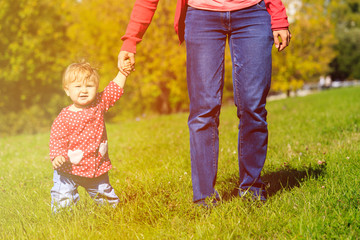 Fototapeta premium mother with little daughter walking in autumn nature