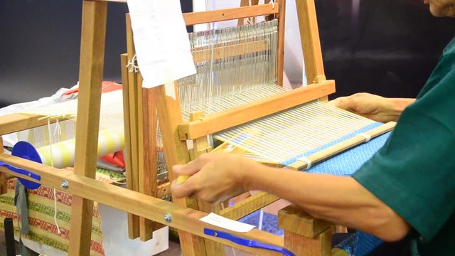 Thai people using small loom or weaving machine for weaving show traveller in Ayutthaya, Thailand