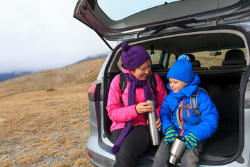 mother and little son travel by car in mountains