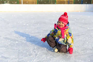 Fototapeta na wymiar happy little girl skating in winter