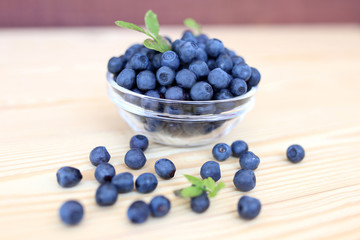 Blueberry on wooden background. Blueberry close up and blueberry background. Berries closeup. 