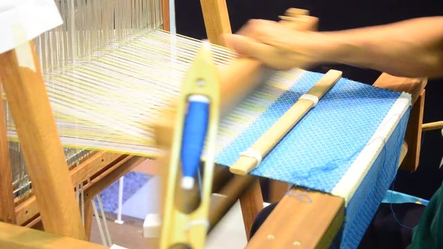 Thai people using small loom or weaving machine for weaving show traveller in Ayutthaya, Thailand