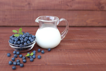 Blueberry on wooden background. Blueberry close up and blueberry background. Berries closeup. Blueberry with milk