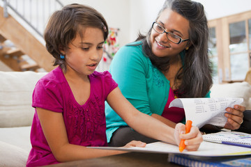 Mother helping daughter with homework