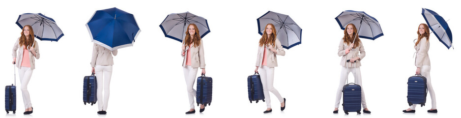 Young woman travelling with suitcase and umbrella isolated on wh