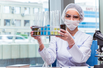 Young student working with chemical solutions in lab