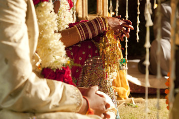 Couple in ornate, traditional Indian wedding clothing