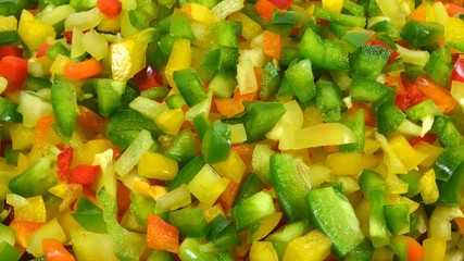 Vegetable background chopped multicolored types sweet pepper. Horizontal orientation picture