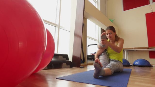 Sport, cute girl performs a handstand Ashtavakrasana asan