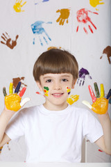 Boy is painting something.