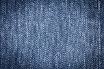 Fototapeta premium Denim jeans texture or denim jeans background with seam of fashion jeans design with copy space for text or image. Dark edged.