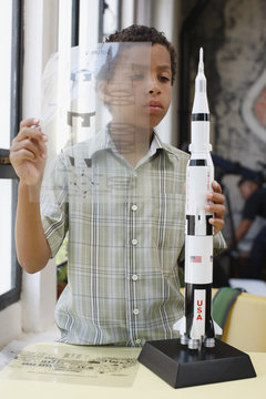 Boy building model rocket