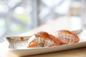  japanese food grilled salmon sushi with seafood sauce on top