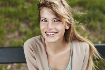 Stunning smile on blond woman with blue eyes, portrait