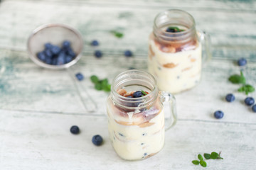Tiramisu in glass jars with fresh blueberries
