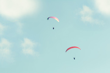 Two paraglider in the sky in sun light