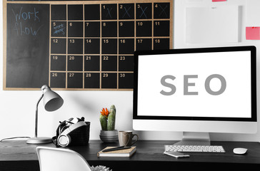 SEO technology concept. Modern workplace interior.