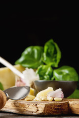 Fototapeta na wymiar Italian parmesan cheese with knife fresh green basil, olive oil,