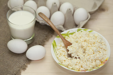 Milk products and eggs on the wooden table. Protein breakfast