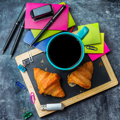 School business stationery croissants mug of coffee on grunge chalkboard