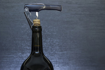 A half opened bottle of red wine