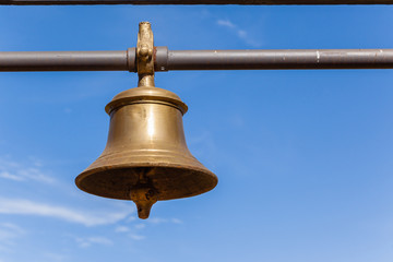 Brass Bell Hand closeup ringing notice instrument.