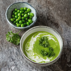 Pea soup puree in an old plate with parsley decoration.