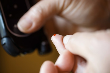 Diabetic patient testing her blood for sugar level