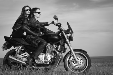 Obraz na płótnie Canvas Active couple riding on the motorbike