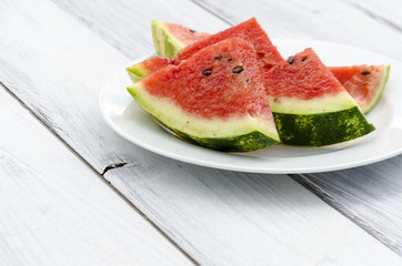 Chunks of juicy ripe watermelon on a white plate