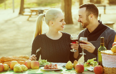 couple having picnic in sunny spring day at countryside