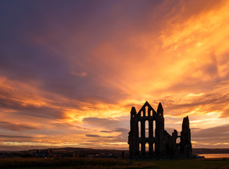 WHITBY, ENGLAND - AUGUST 12: Whitby Abbey against a dramatic sunset. In Whitby, North Yorkshire, England. On 12th August 2016