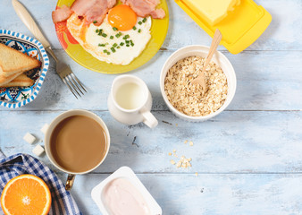 Breakfast bacon and eggs, cereal and toast. Top view