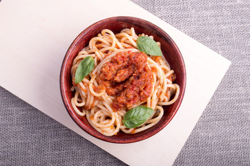 Top view of cooked spaghetti with tomato relish