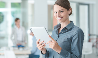 Obraz premium Confident business woman using a touch screen tablet