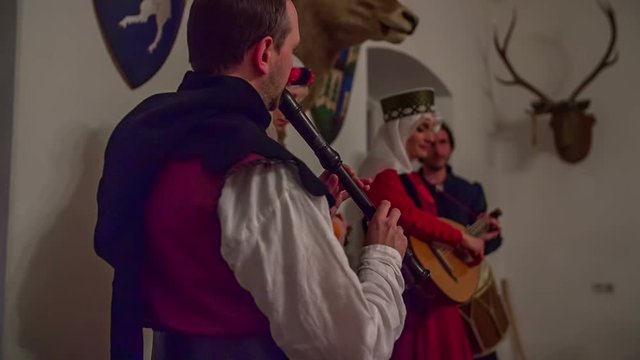 The members of a royal family are performing for the visitors who came to see a medieval day. Close-up shot.
