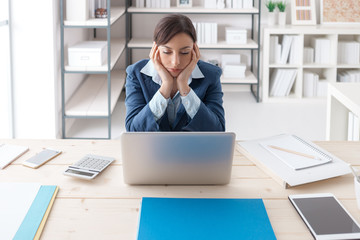 Fototapeta premium Bored businesswoman in her office