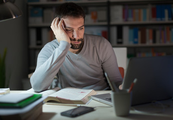 Sleepy young man at desk