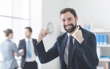 Cheerful businessman with raised fists