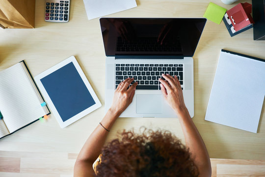 Overhead picture of woman typing on laptop
