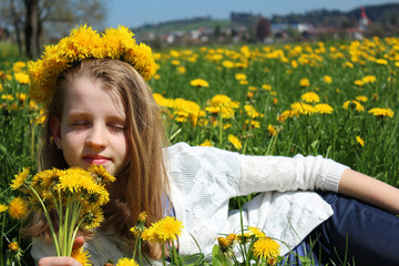 young girl on the dandalion meadow