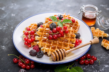 Waffles with fresh berries and honey