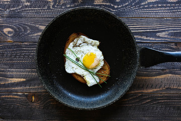 Veggie Food composition with half avocado over a darkdish