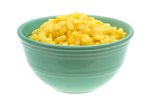 Shoepeg white corn with a butter sauce in a bowl.
