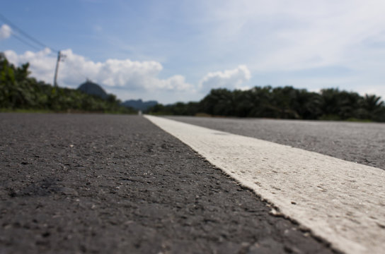 Close up asphalt road texture with white stripe