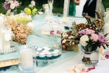 Chests with nuts stand on the table with sweets