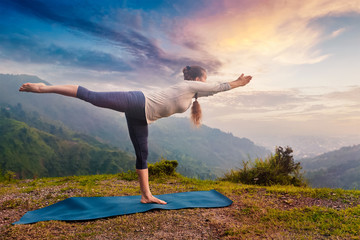 Woman doing Ashtanga Vinyasa Yoga asana Virabhadrasana 3 Warrior