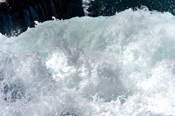 Sea foam of the waves crushing into the shore texture.