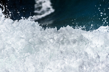 Sea foam of the waves crushing into the shore texture.