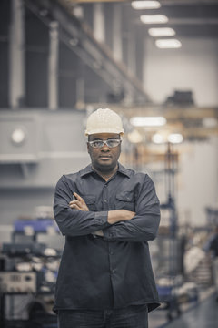 Portrait of man standing in factory